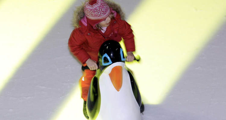 Kind mit Pinguin-Lauflernhilfe